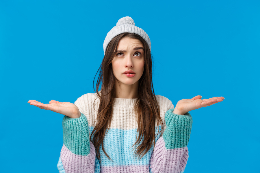 Shopping, Discounts And Advertising Concept. Waist Up Indecisive, Thoughtful Young Woman Searching Gifts For Christmas Holidays, Raising Palms Holding Something In Hands, Two Variants, Making Choice